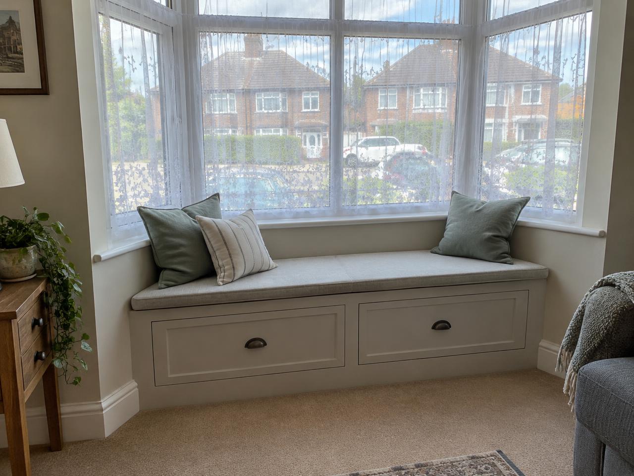 Illustrative bay window seat with drawers in a semi-detached house